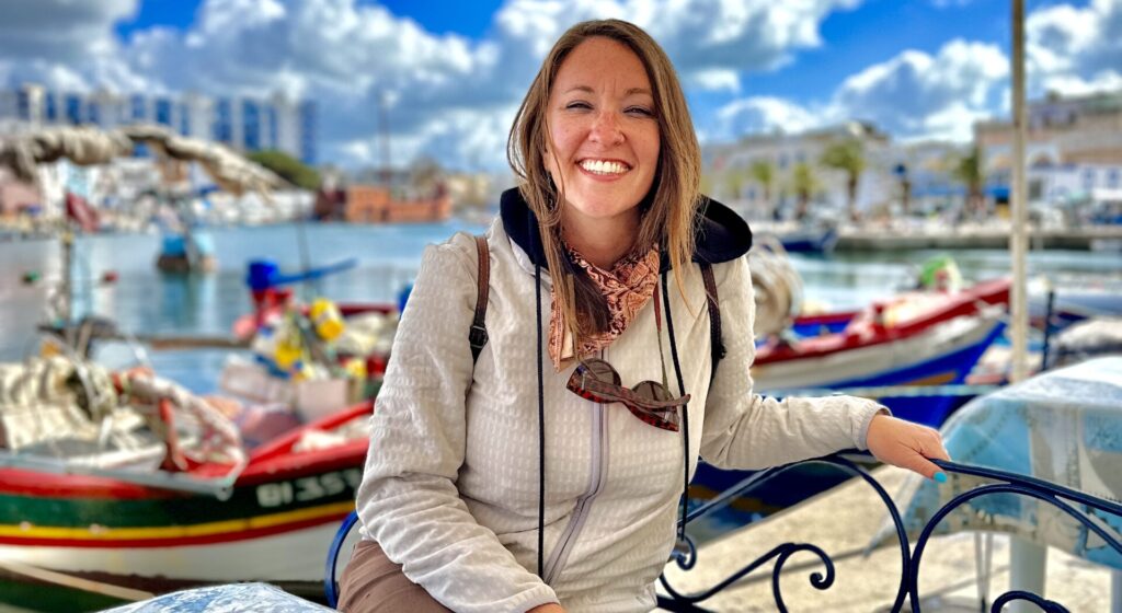 Nicki smiles at the camera at an outdoor cafe in Bizerte, Tunisia.